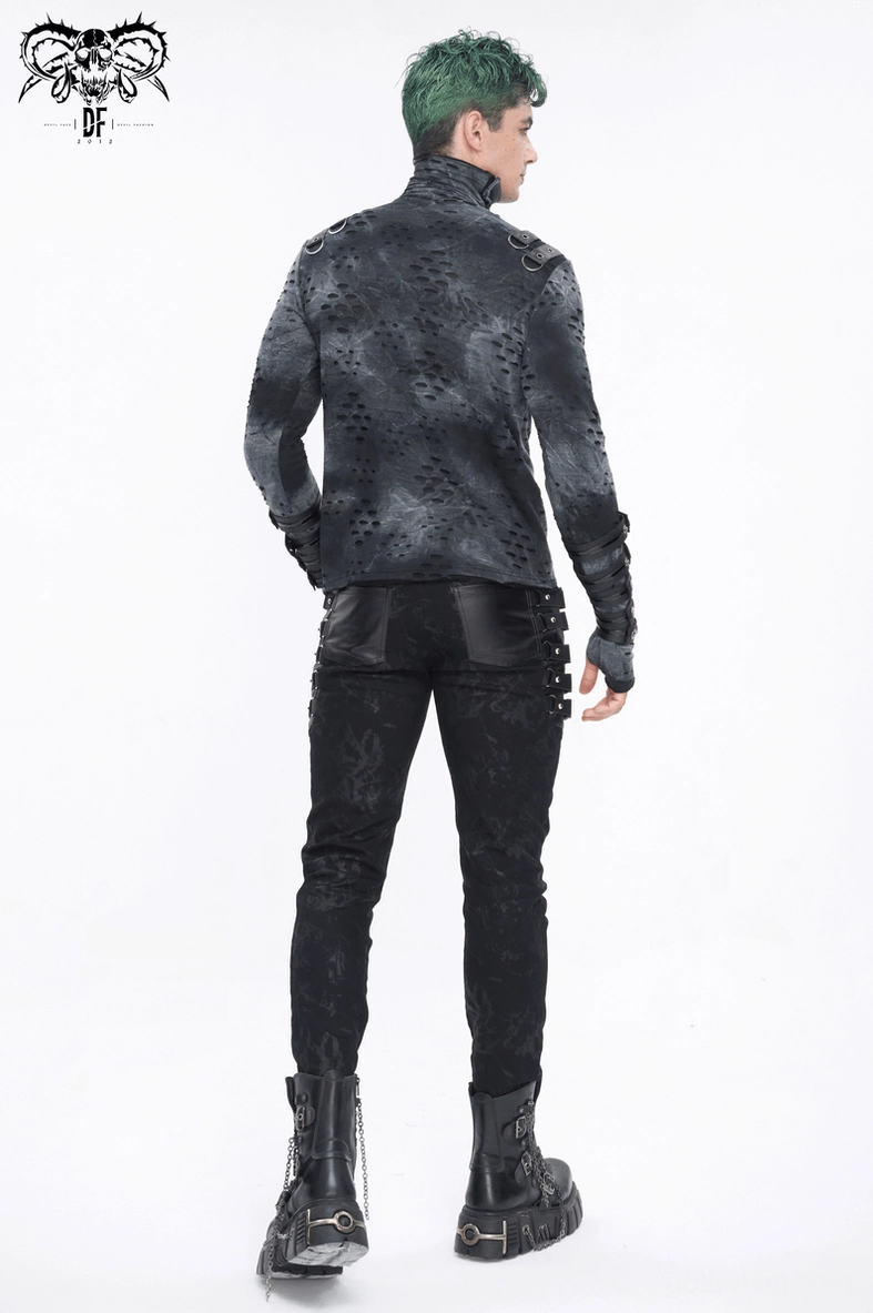 Fashion styling shot of black gothic slim-fit buckled strap trousers worn with platform boots
