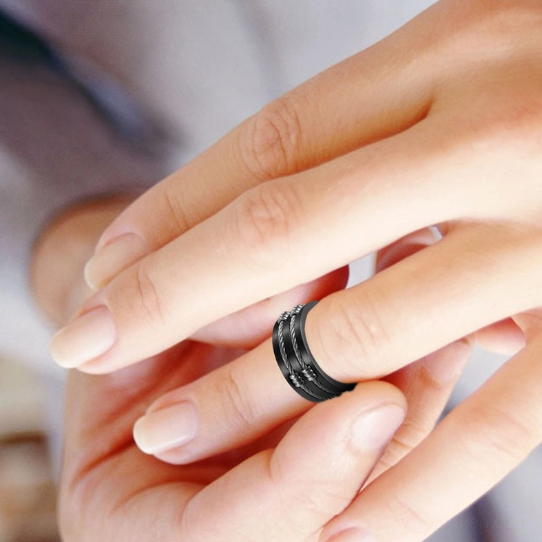 Unisex stainless steel gothic ring worn on female model's middle finger showing dual-tone design