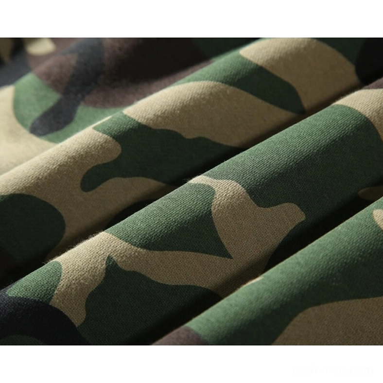 Soft fleece fabric texture of woodland camouflage pattern in army green, brown and tan tones