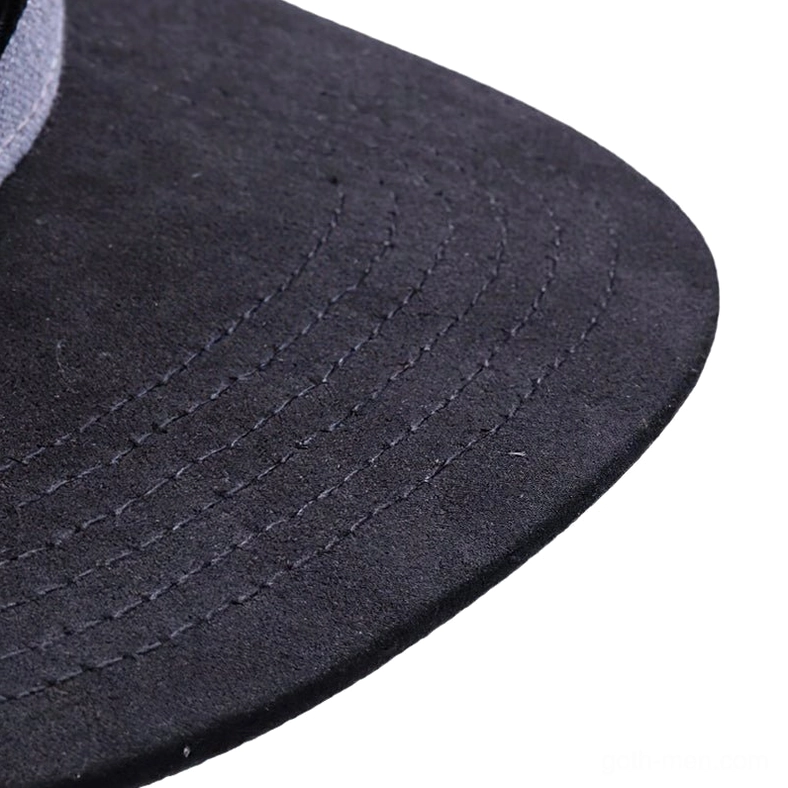 Close-up detail of gothic snapback cap brim showing black suede-like fabric texture and precision stitched seams