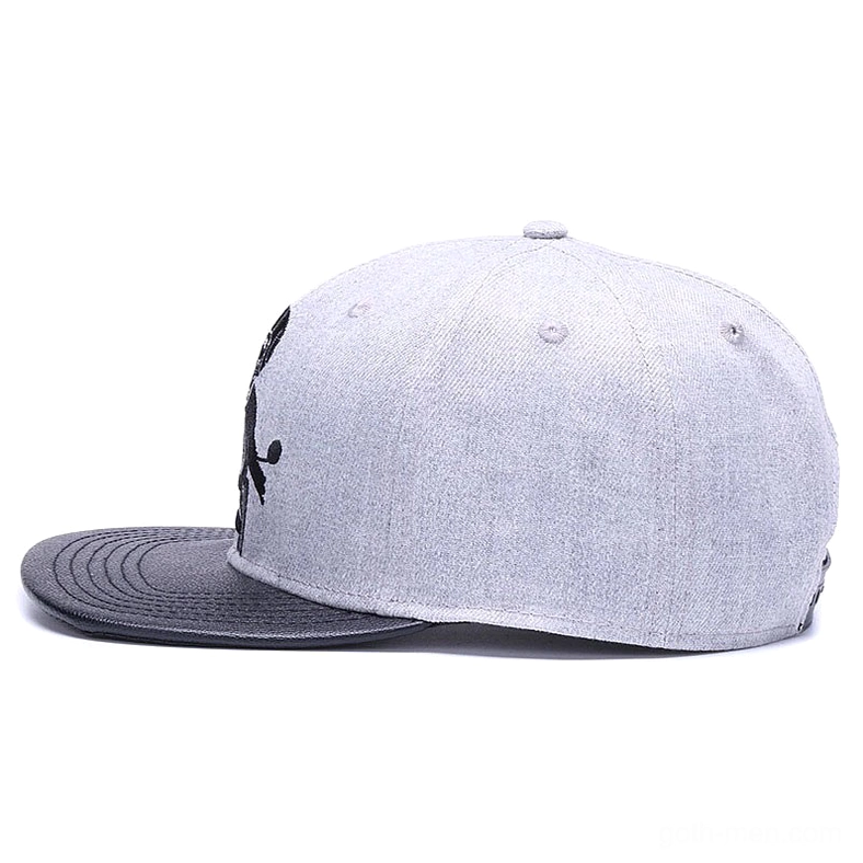 Side profile of grey gothic snapback cap displaying partial embroidered skeleton motorcyclist motif
