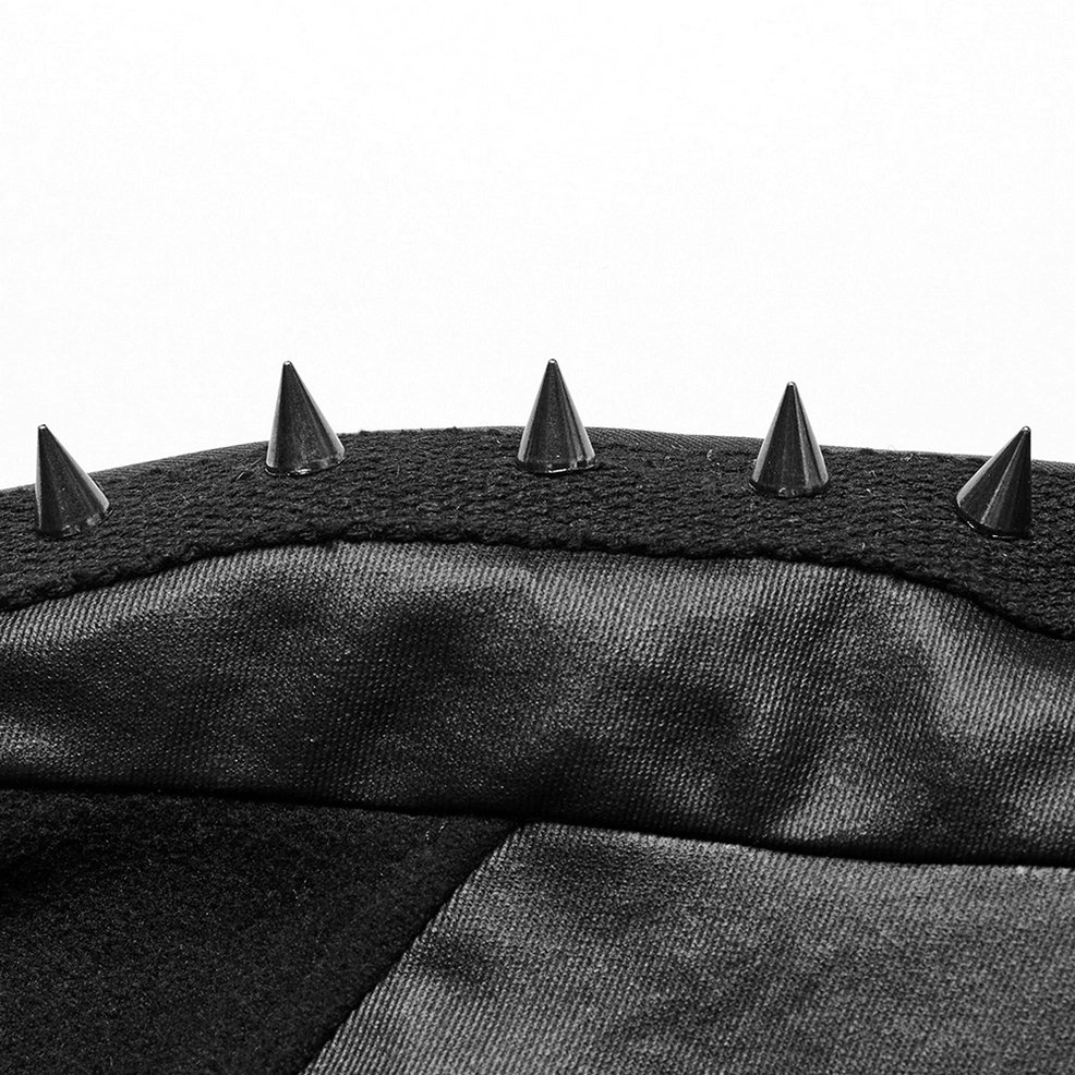 Close-up detail of metal eyelets and leather-like trim on black gothic cape collar