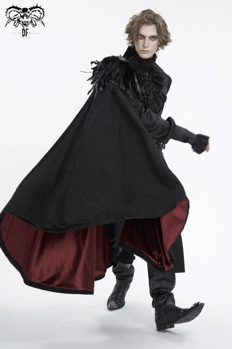 Three-quarter view of black feathered asymmetric gothic cape highlighting theatrical design and wine-red inner lining