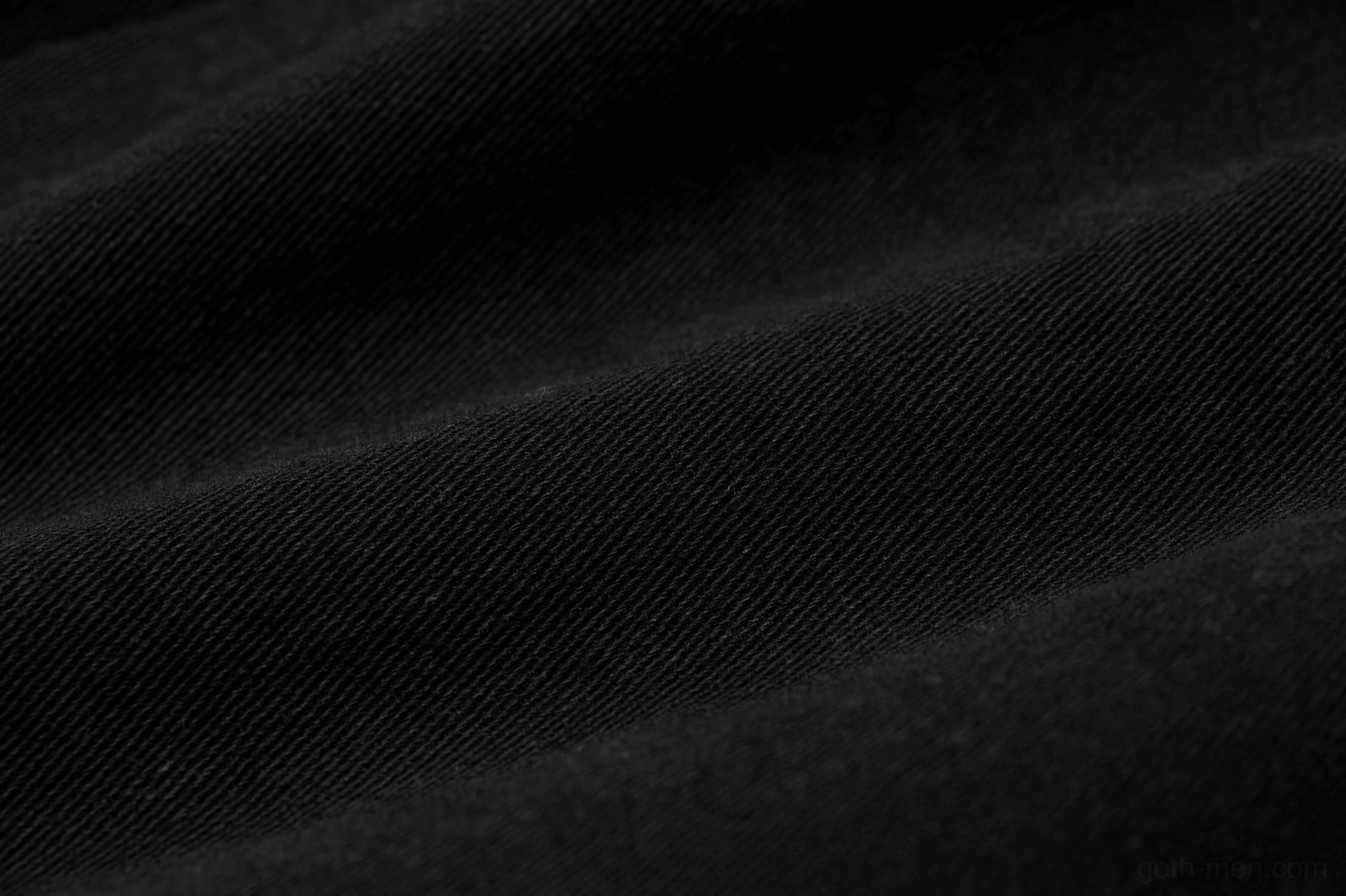Close-up of dense black woven twill fabric texture showing premium material quality