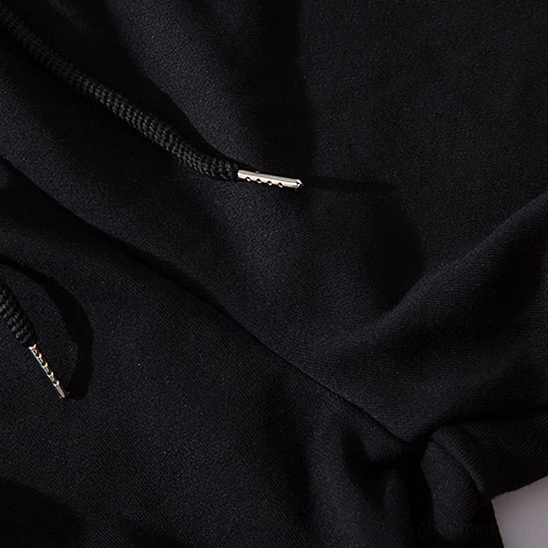 Close-up texture of black gothic cargo joggers drawstring with metal aglet and knit fabric ribbing