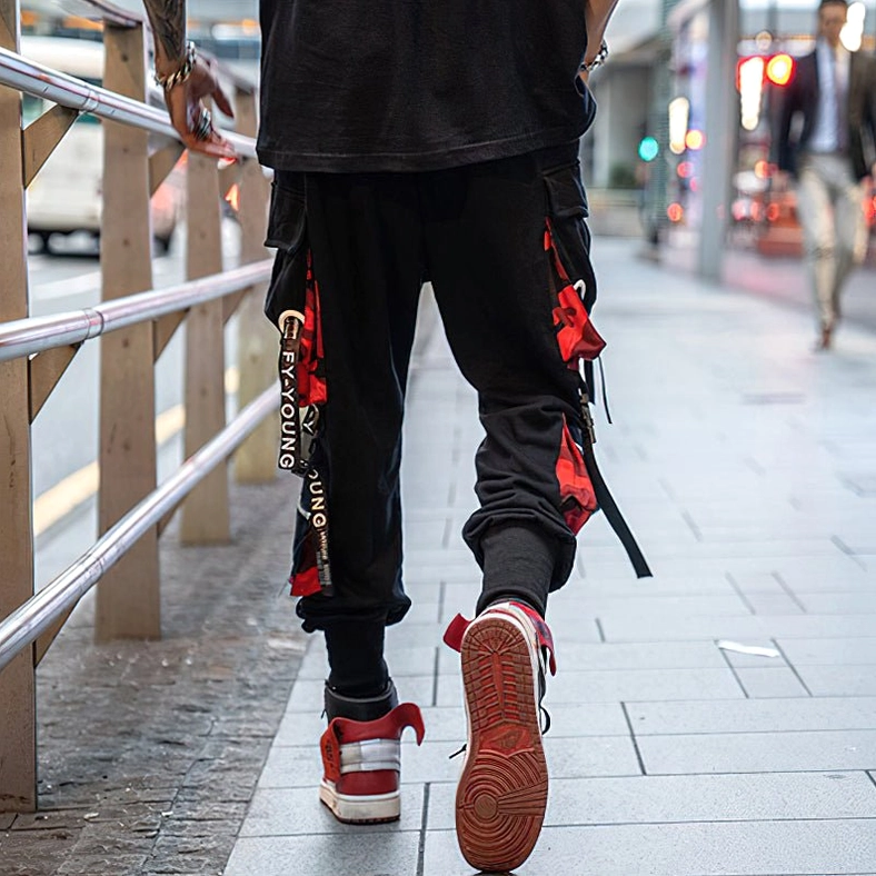 Black gothic cargo joggers lifestyle flat lay arrangement showing versatile styling options and design elements
