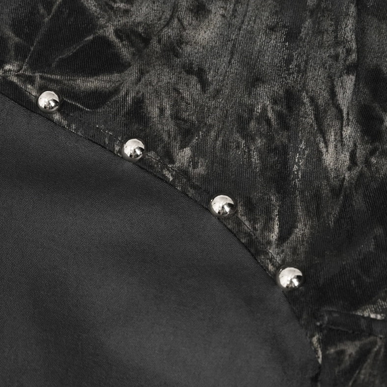 Black gothic cargo joggers detail shot showing spliced fabric construction and rivet trim work