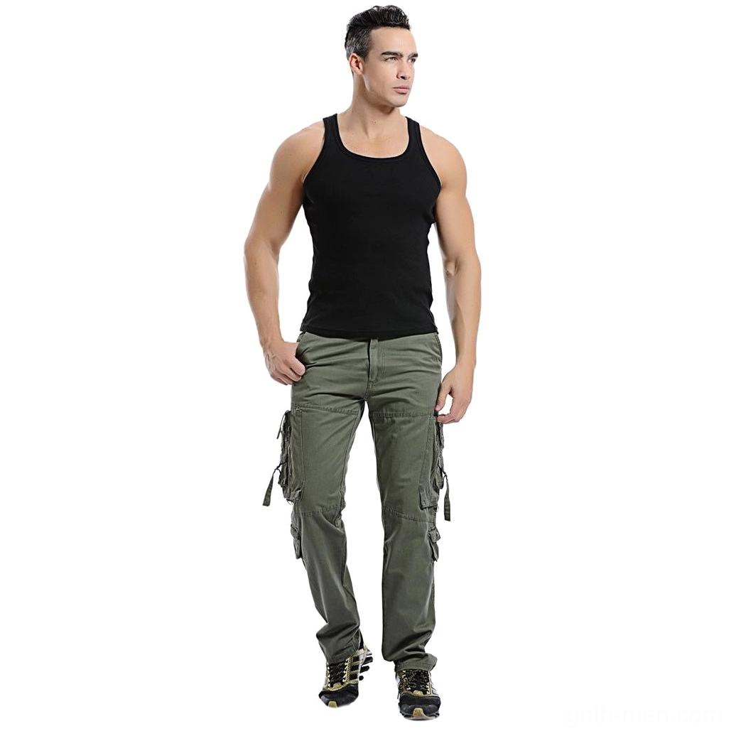 Male model wearing army green cargo pants with black tank top side view showcasing fit and length