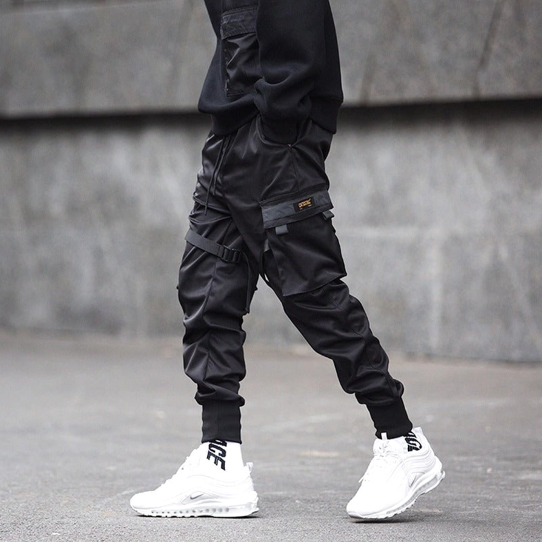 Black cargo joggers with brand patch on pocket - rear view outdoor setting