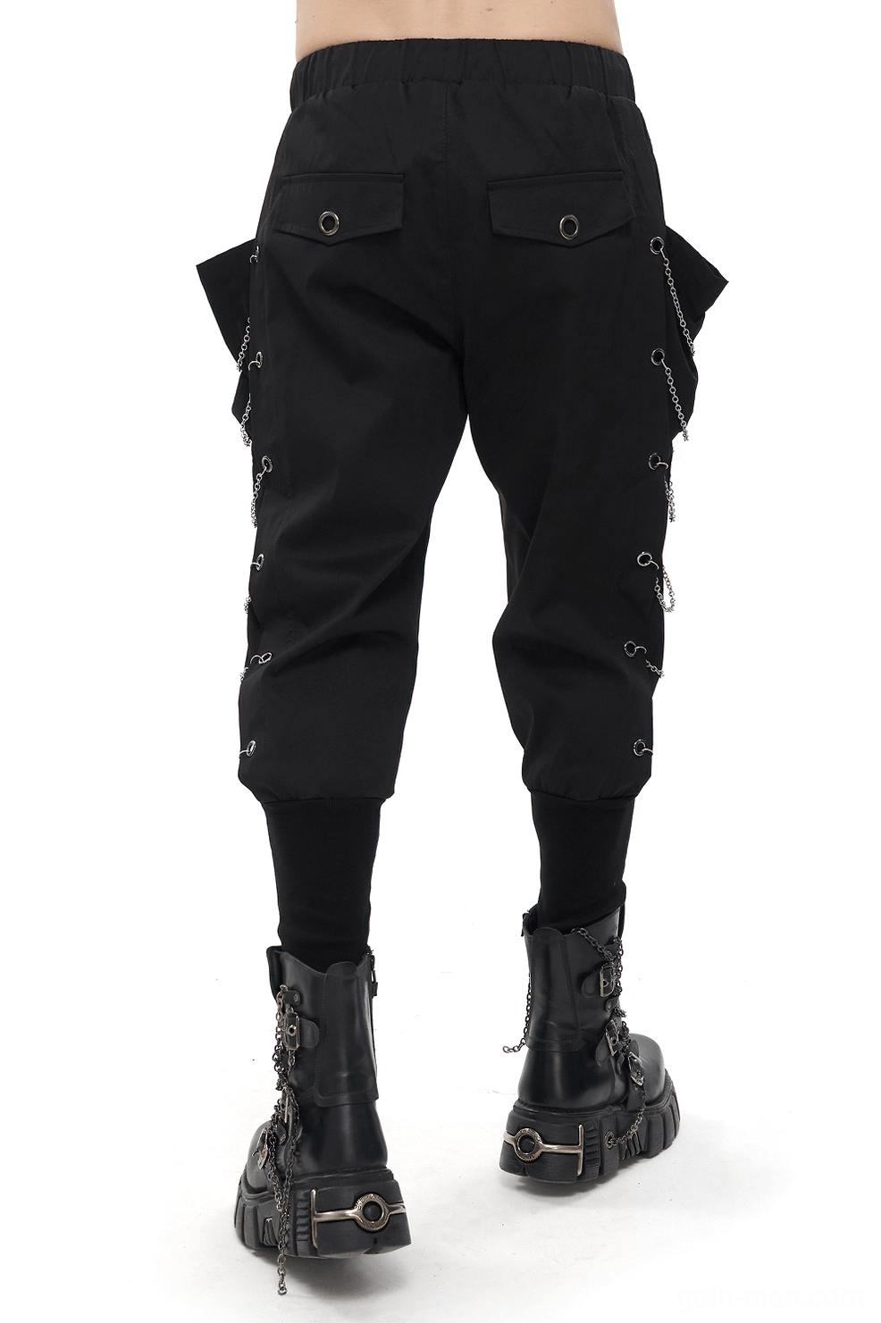 Rear view of black gothic cargo pants displaying back flap pockets and chain eyelet trim detail