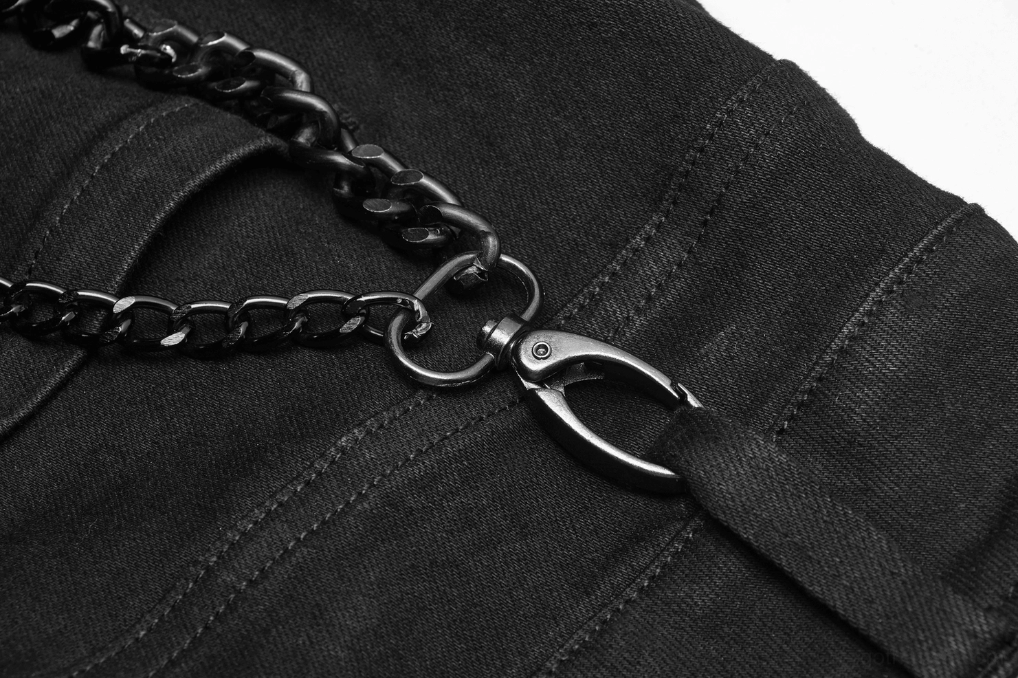 Close-up detail of black curb chain and metal lobster clasp attached to Gothic cargo pants