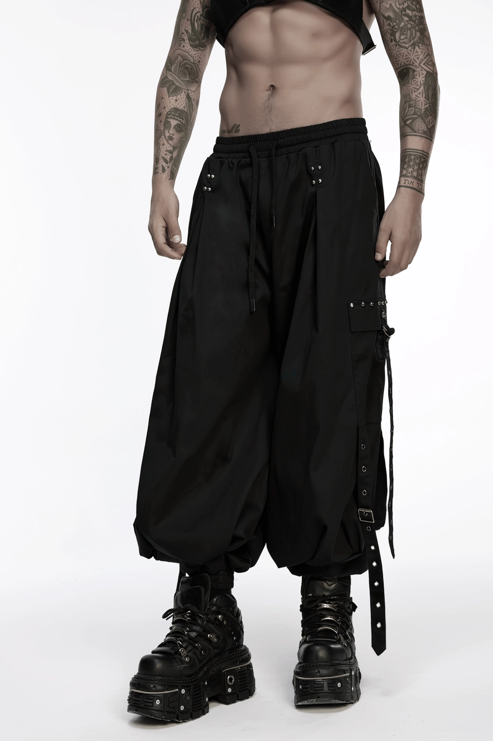 Black gothic cargo pants worn with cyberpunk accessories and metal jewelry combination