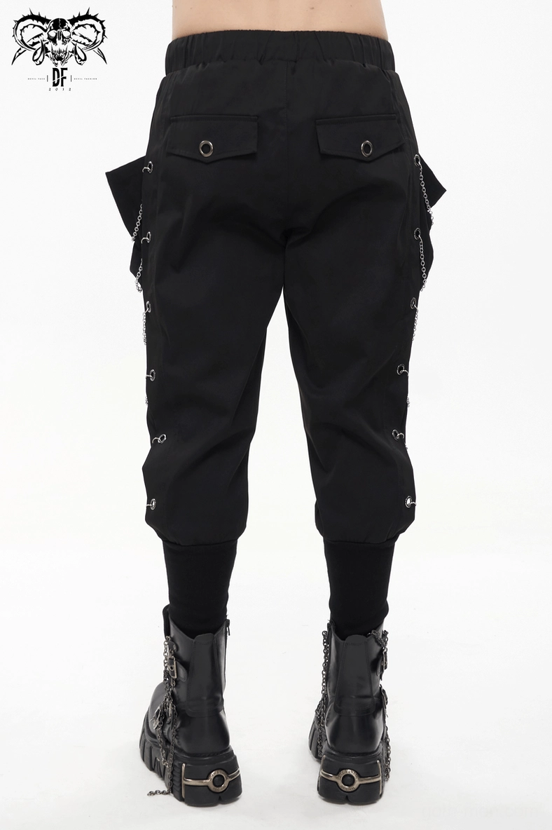Detailed shot of cargo pants construction showing fabric texture and chain eyelet industrial aesthetic