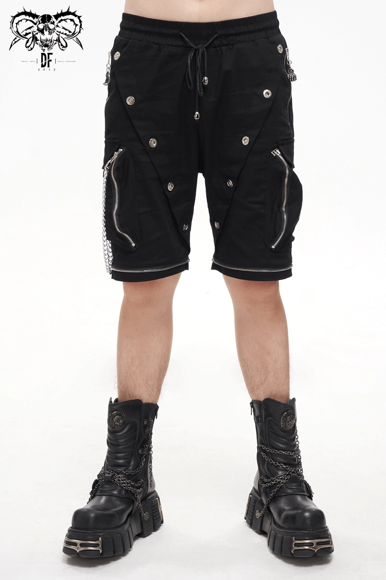 Full-length view of model wearing black gothic cargo pants with metal chain and detachable hardware