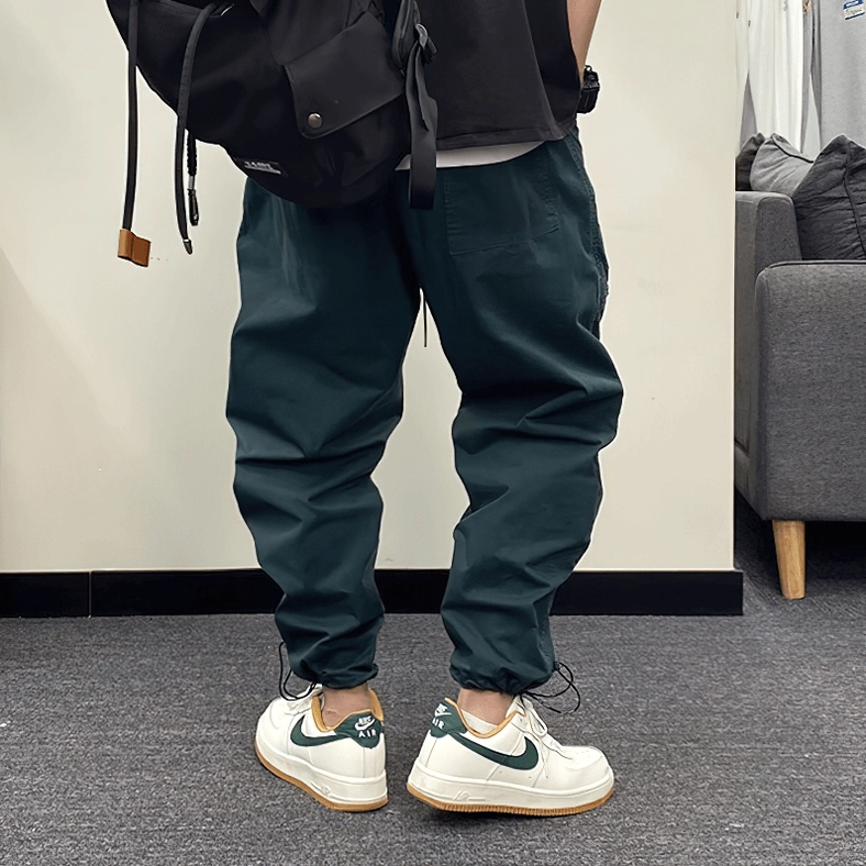 Dark gothic cargo harem pants hem and ankle cuff detail showing tapered closure and drawstring mechanism