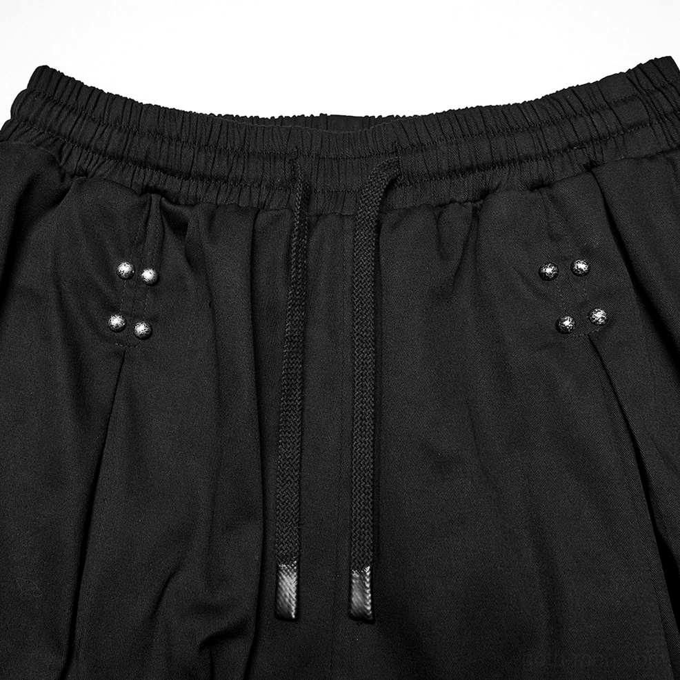 Black gothic cargo pants detail shot of metal rivets, grommets, and industrial hardware