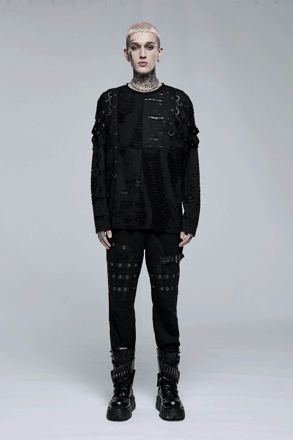 Profile view of black gothic cargo pants on male model demonstrating fitted cut and thigh pocket placement