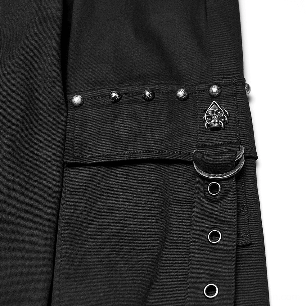 Close-up of black gothic cargo pants pocket showing metal rivets and skull emblem with D-ring