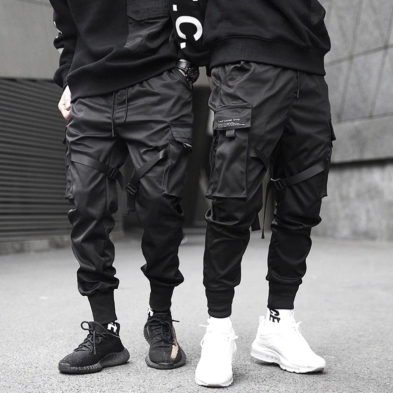 Men wearing black gothic cargo pants with ribbons - outdoor street style side view