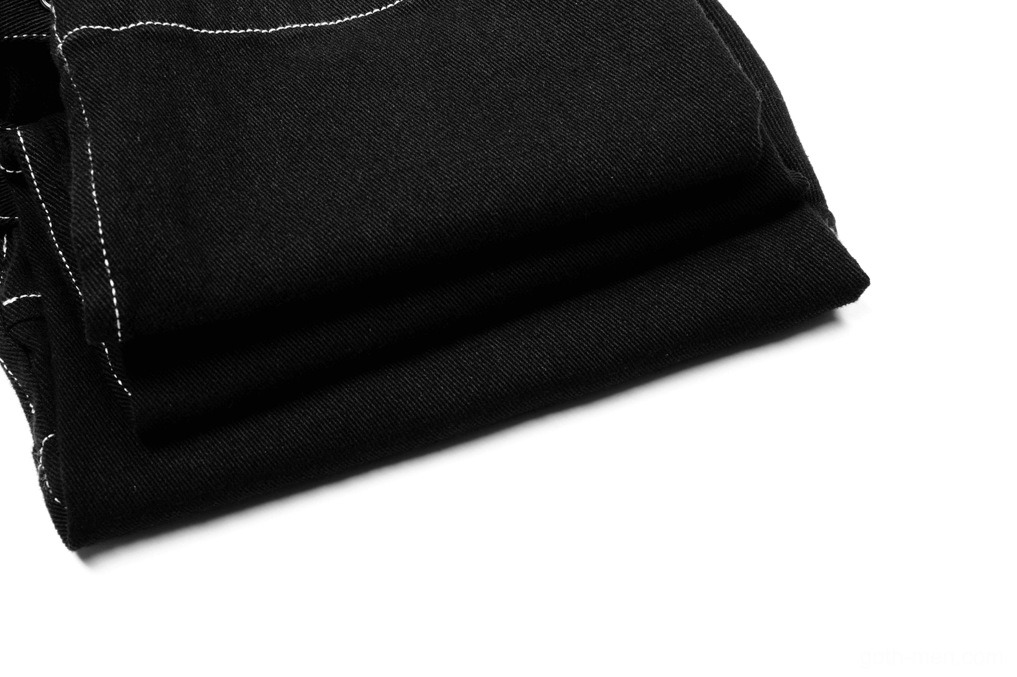 Close-up of black twill fabric texture with white contrast stitching on gothic cargo pants