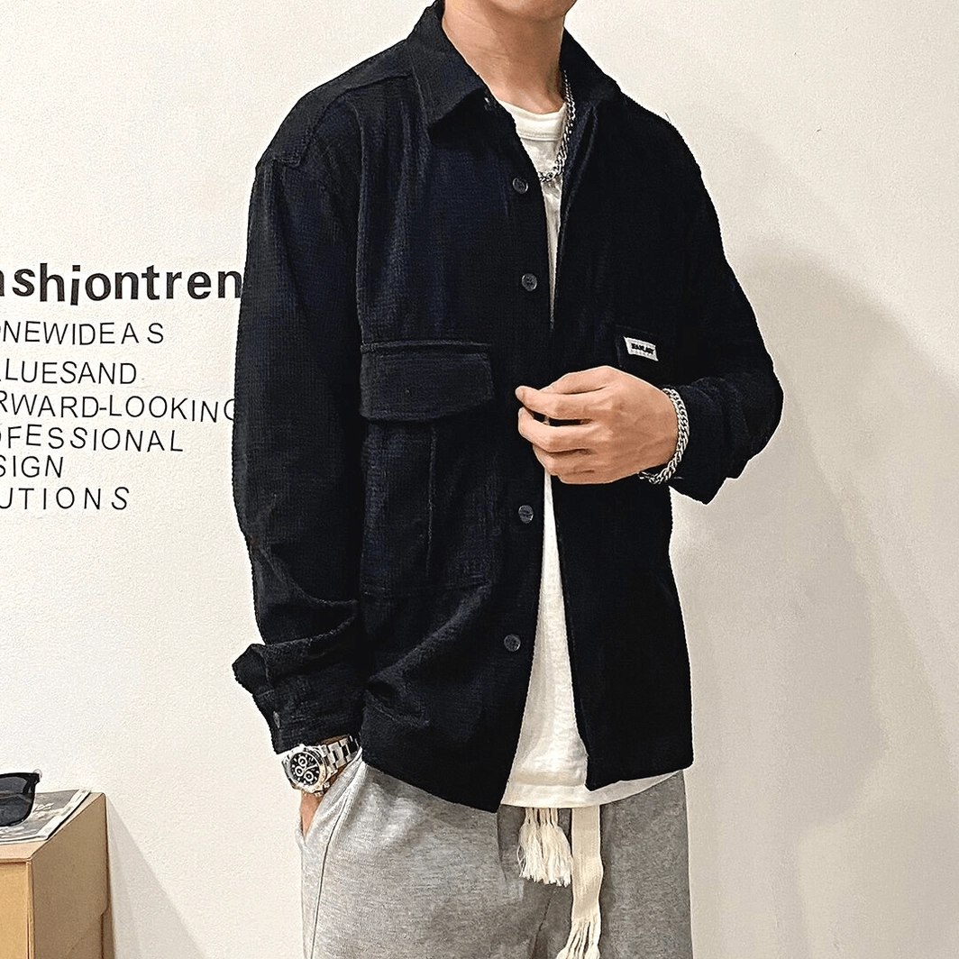 Oversized gothic cargo shirt detail shot emphasizing dual cargo pockets, button placket, and broadcloth construction quality for alternative fashion wear
