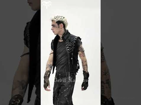 Side profile view of fitted black gothic chain vest worn on male model paired with leather garments in dark studio setting