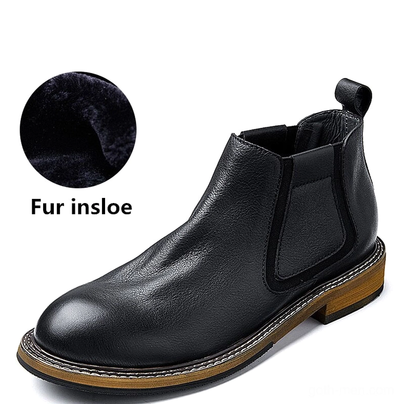 Single men's black leather Chelsea boot side profile, smooth leather upper with heel pull tab
