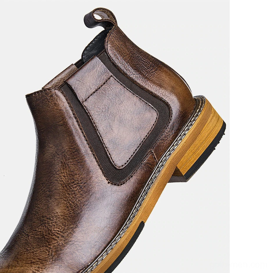 Men's black leather Chelsea boots full pair display, slip-on design with pleated detail accent