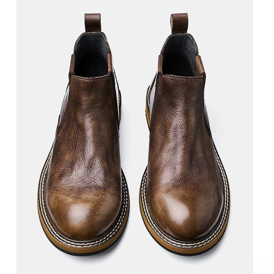 Pair of men's brown leather Chelsea boots overhead top view, round toe design, vintage finish