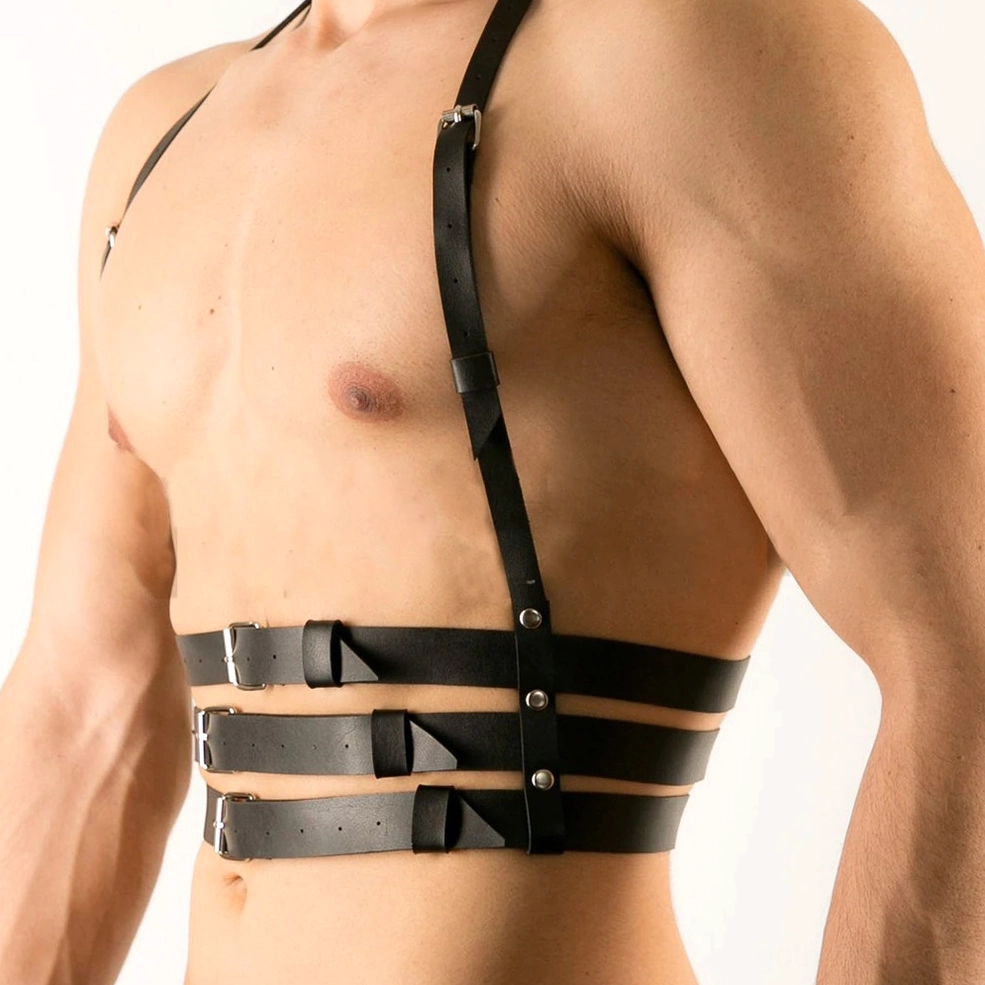 Close-up of silver metal buckles and riveted faux leather construction on men's gothic chest harness