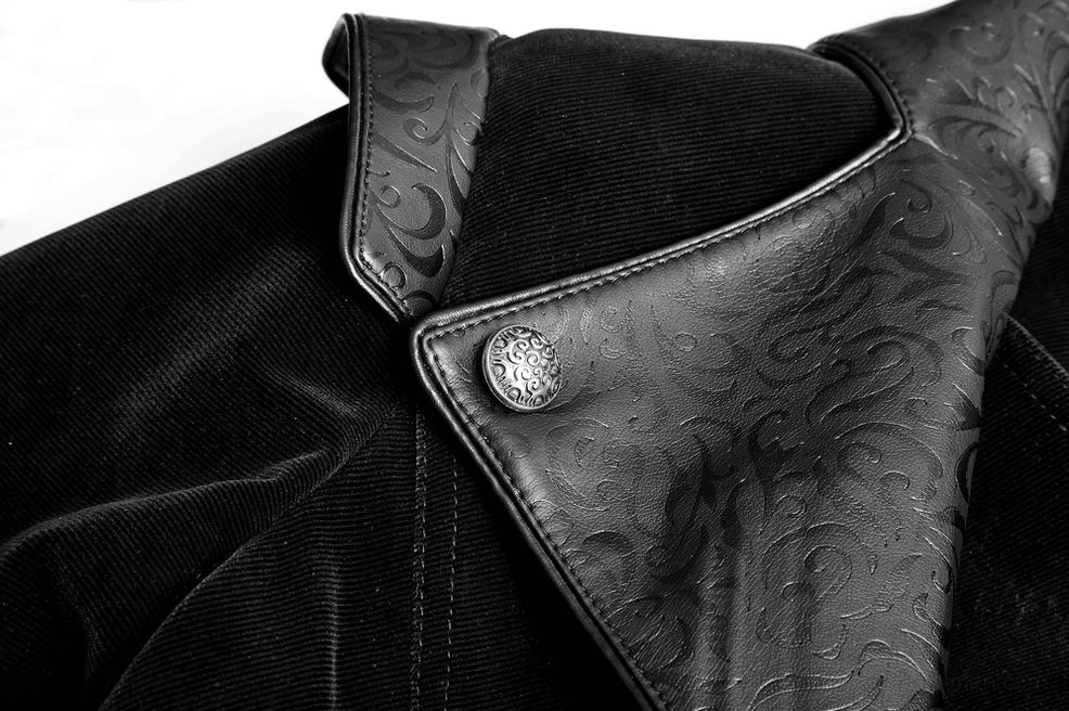 Embossed leather collar detail of gothic velvet cloak showing carved metal button and gothic ornamentation close-up