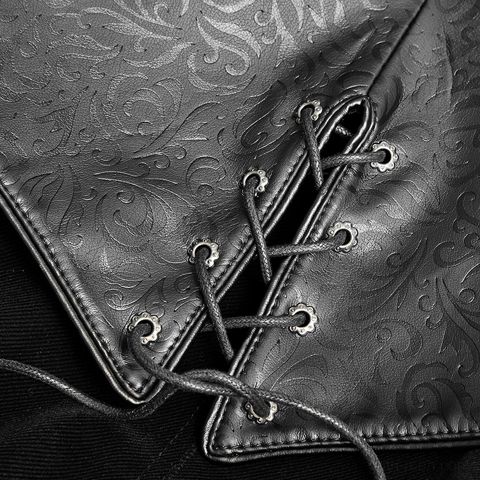 Close-up of gothic cloak shoulder capelet and embossed leather cuff showing layered dimensional design
