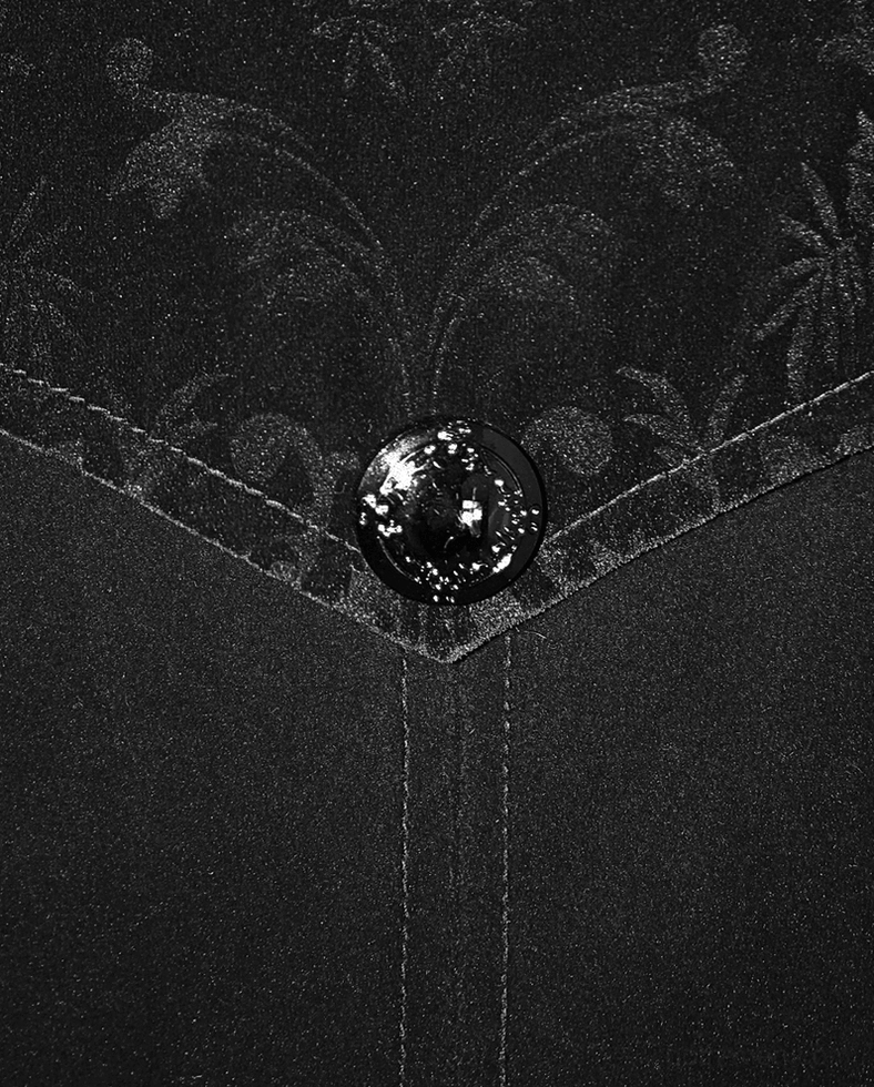 Black velvet gothic coat interior or construction detail showing quality craftsmanship and seaming