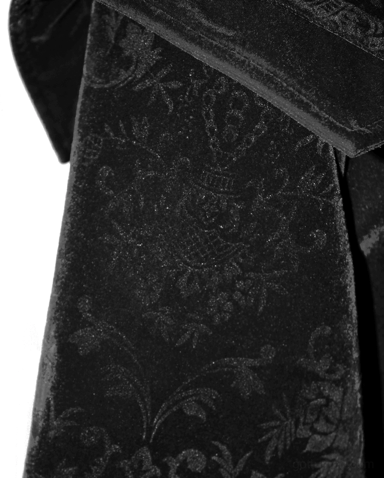 Black velvet fabric close-up showing embossed floral pattern and folded collar edge texture detail