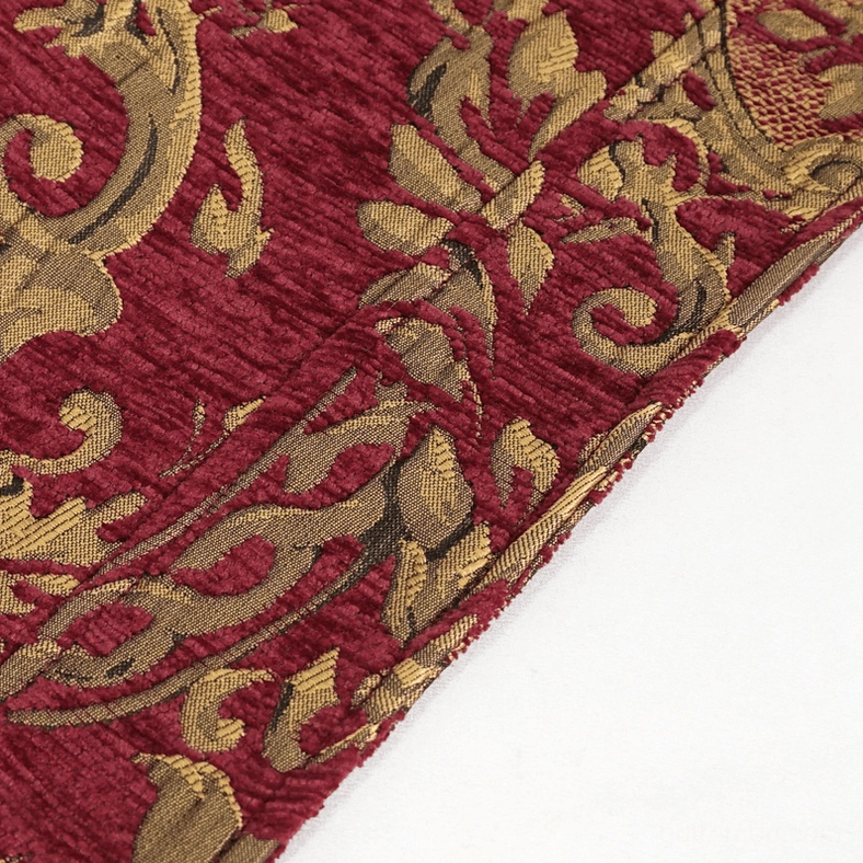 Close-up textile detail of men's gothic coat showing embossed gold floral jacquard pattern woven into wine red base fabric