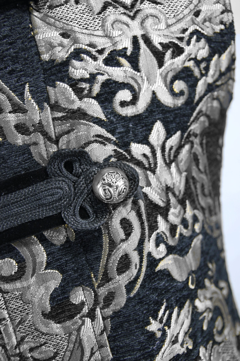 Metal frog button ornament close-up on black silver jacquard gothic coat fabric