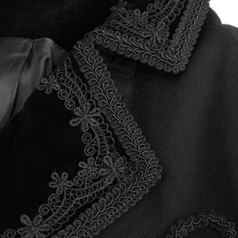 Vintage scroll pattern embroidery detail on black velvet gothic coat fabric, decorative stitching close-up
