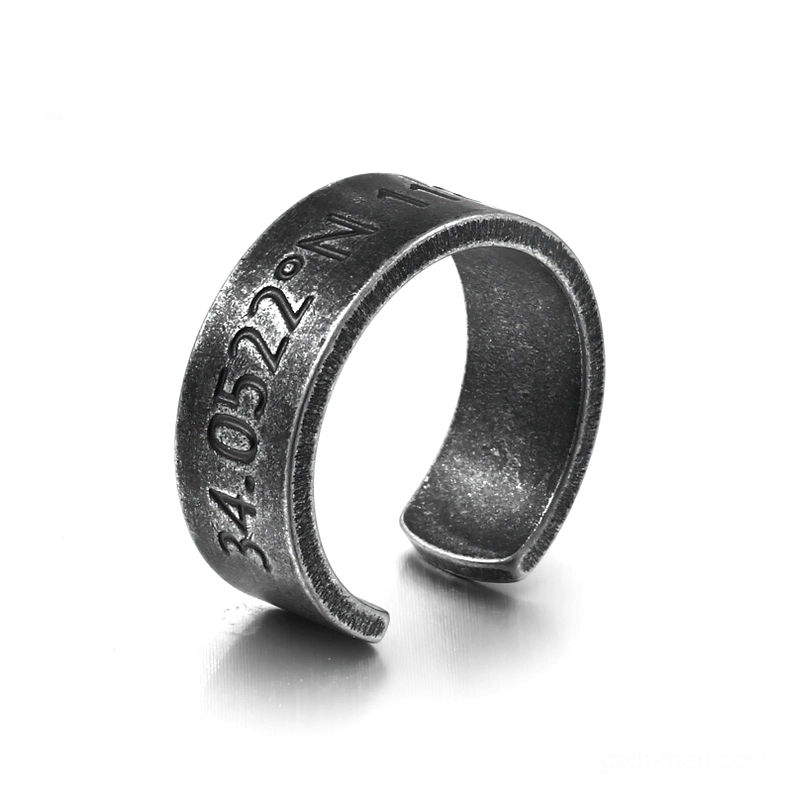 Dark aged stainless steel open cuff coordinate ring with engraved inscription, left oblique view on white studio background