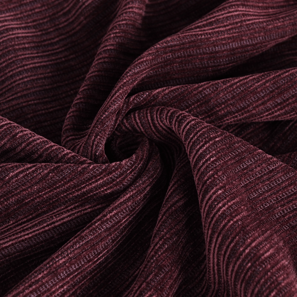Leg silhouette detail of fitted wine red corduroy gothic trousers showing tapered leg opening and fabric drape
