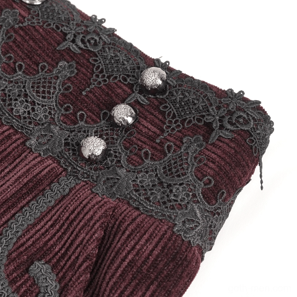 Top-down close-up of decorative metal button hardware and intricate black lace waistband trim on gothic corduroy trousers