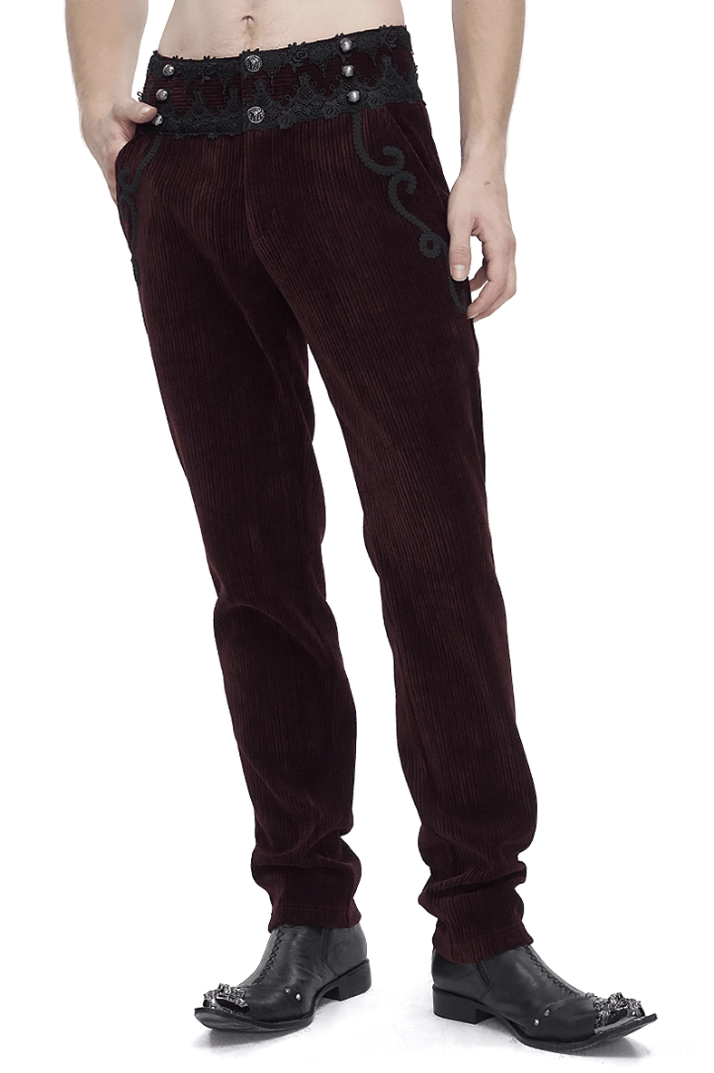 Wine red corduroy gothic trousers with black lace waist trim worn by male model, side front view showing fitted silhouette