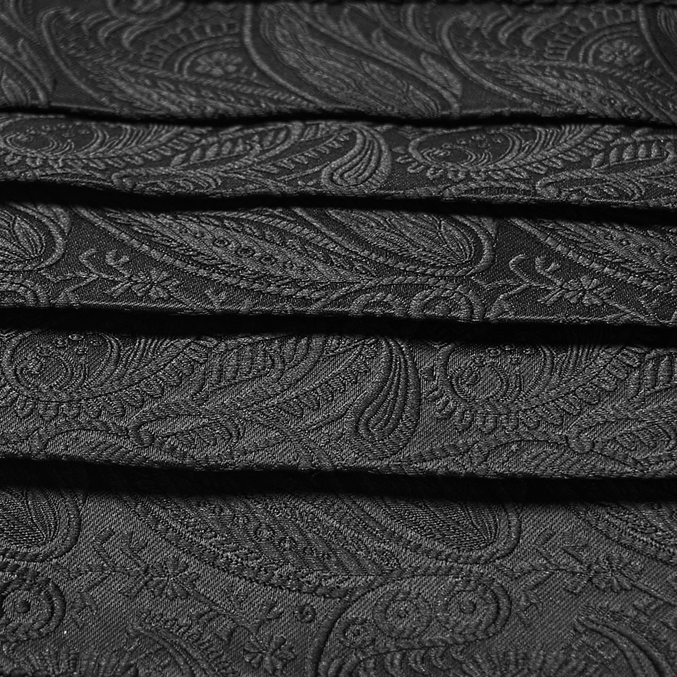 Close-up detail of black jacquard gothic waist belt showing layered pleated construction and intricate paisley jacquard texture