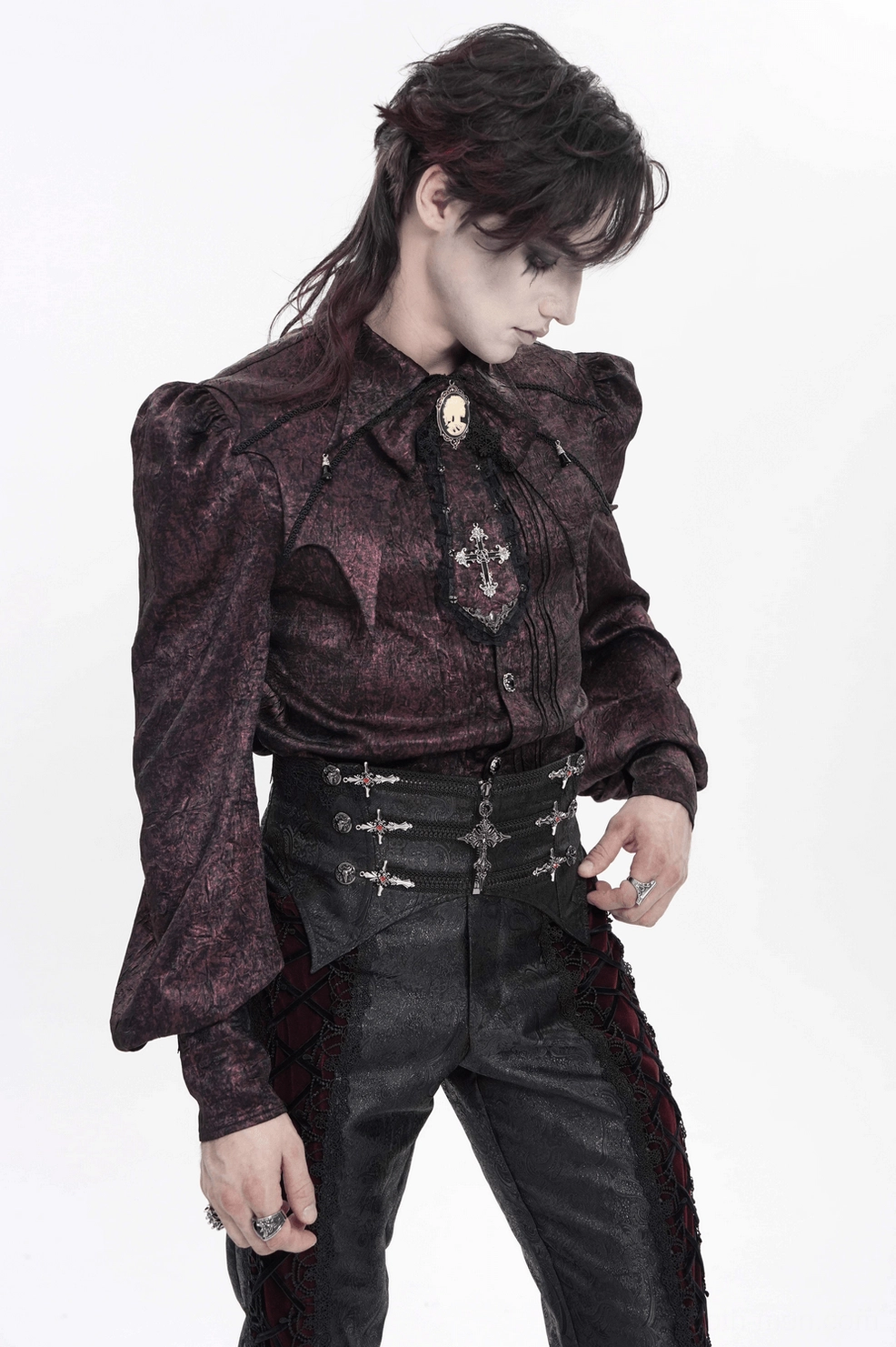 Close-up of gothic waist corset ornate silver cross decorations and intricate brocade weave pattern