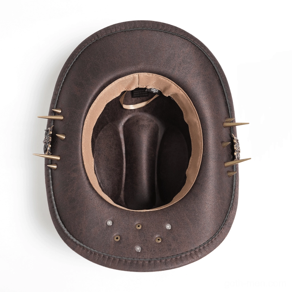 Inside view of brown gothic cowboy hat showing light brown interior lining, spike brim trims, and metal hardware positioning