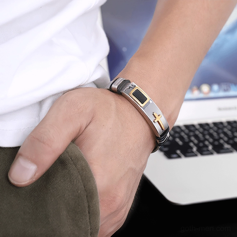 Male model wearing black and silver gothic cross stainless steel bracelet on wrist in casual office daily wear environment