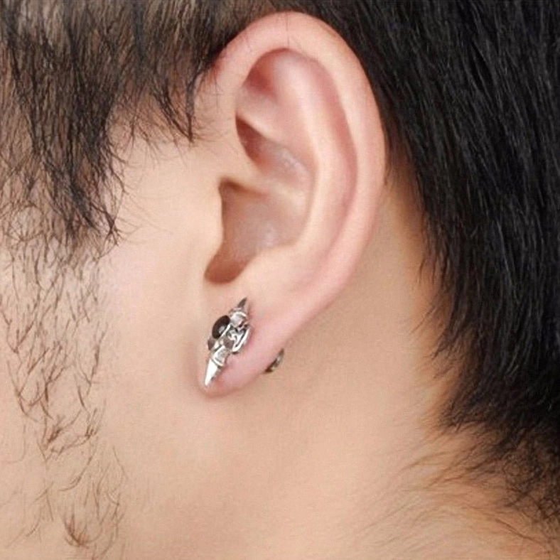 Gothic cross spike stud earring worn on male earlobe - styled close-up showing real-world wearability