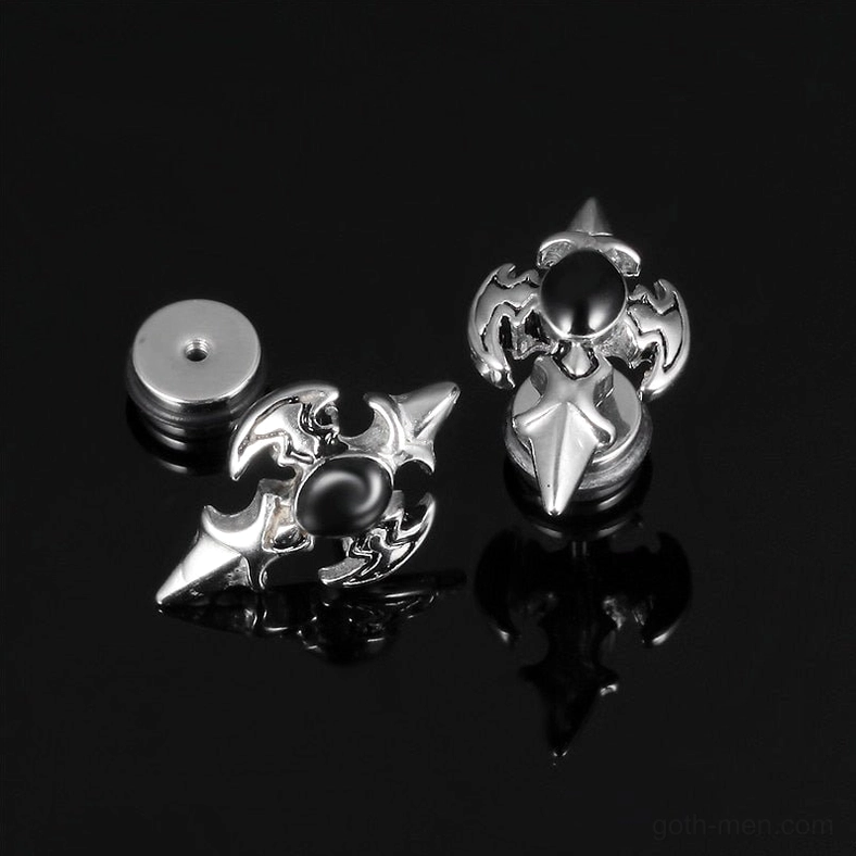 Silver gothic cross spike stud earrings showing screw-back fastener system - top view on glossy black background