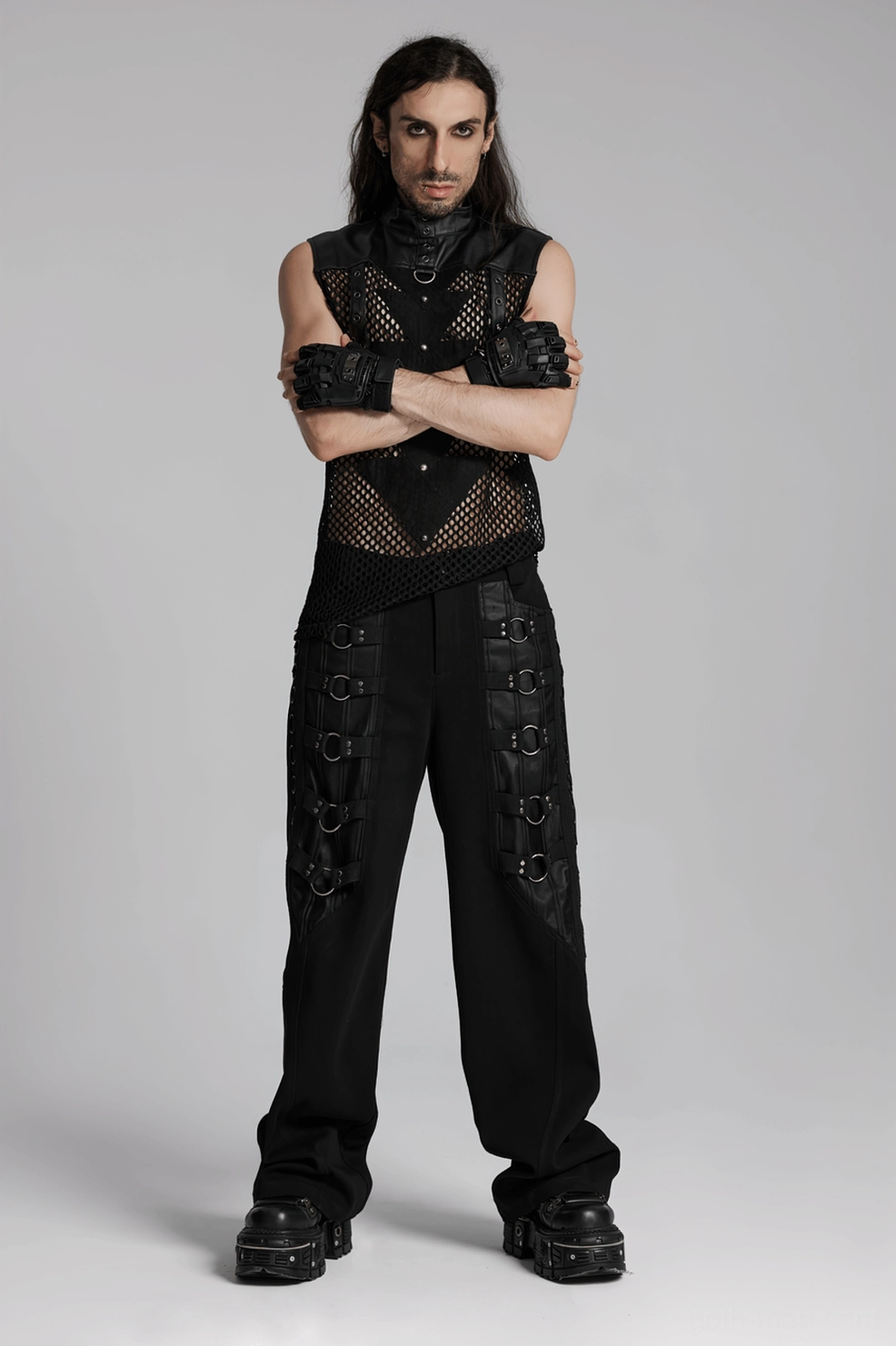 Full body styling shot of male model wearing black gothic spiked fingerless gloves with complete dark outfit ensemble