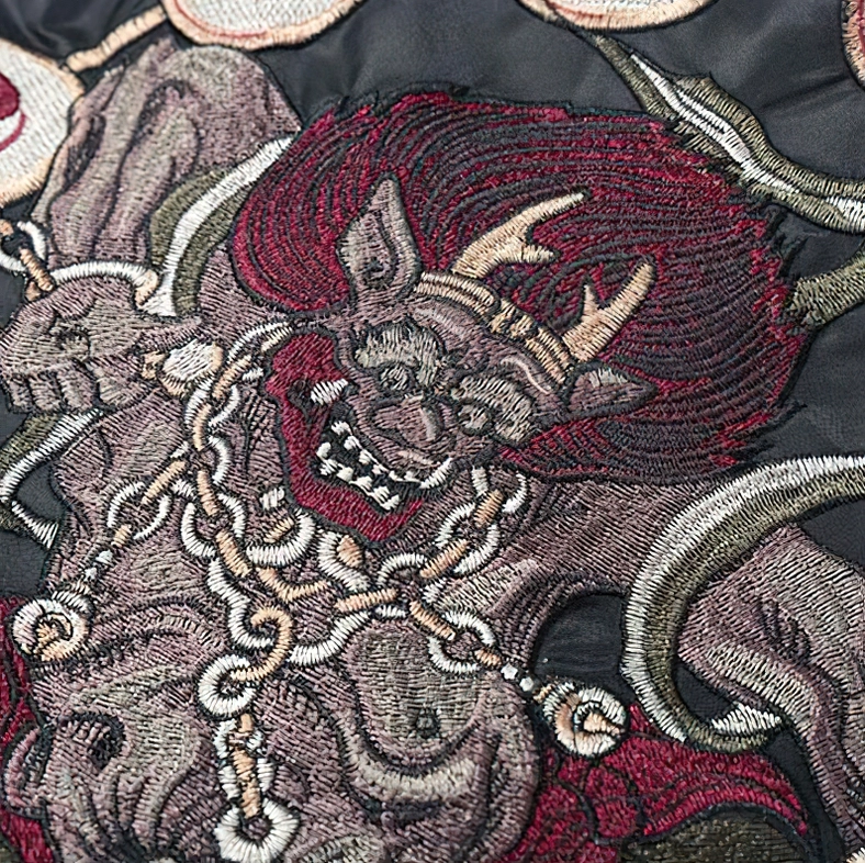 Back embroidery detailed view - horned demon with red accents and chain embroidery on gothic jacket