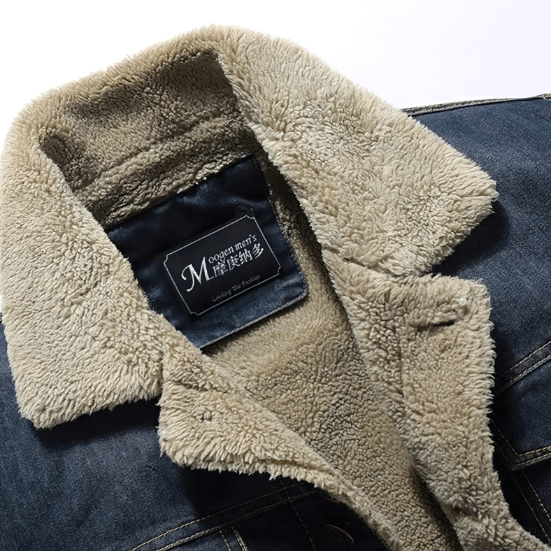 Close-up of men's gothic denim jacket collar, faux shearling lapel, fuzzy fleece lining, branded fabric label detail